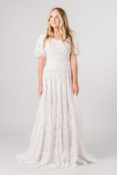 Front view boho lace modest wedding dress with flutter sleeves. This modest wedding dress is from LatterDayBride, a bridal shop located in downtown Salt Lake City, Utah.