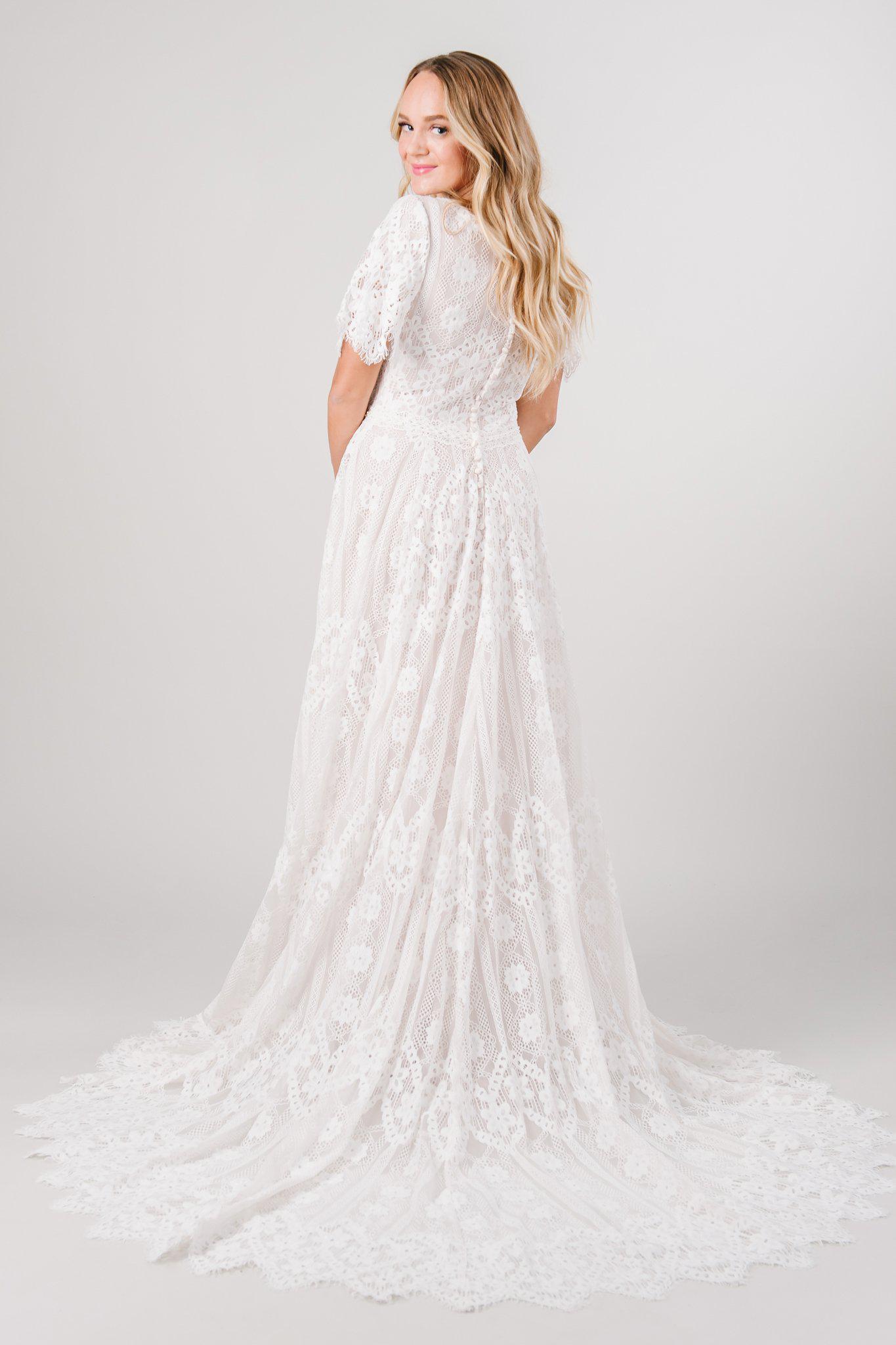 Back view boho lace modest wedding dress with flutter sleeves. This modest wedding dress is from LatterDayBride, a bridal shop located in downtown Salt Lake City, Utah.