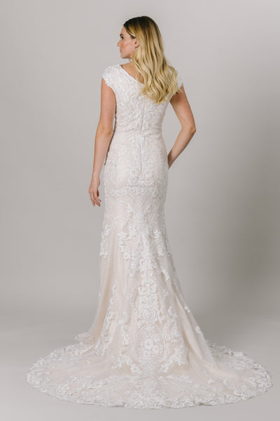 This fit-and-flare, modest wedding dress features a flattering V-neckline and a double lace design that creates amazing dimension.  Available in Ivory/Ivory. From a bridal shop called LatterDayBride in Salt Lake City.