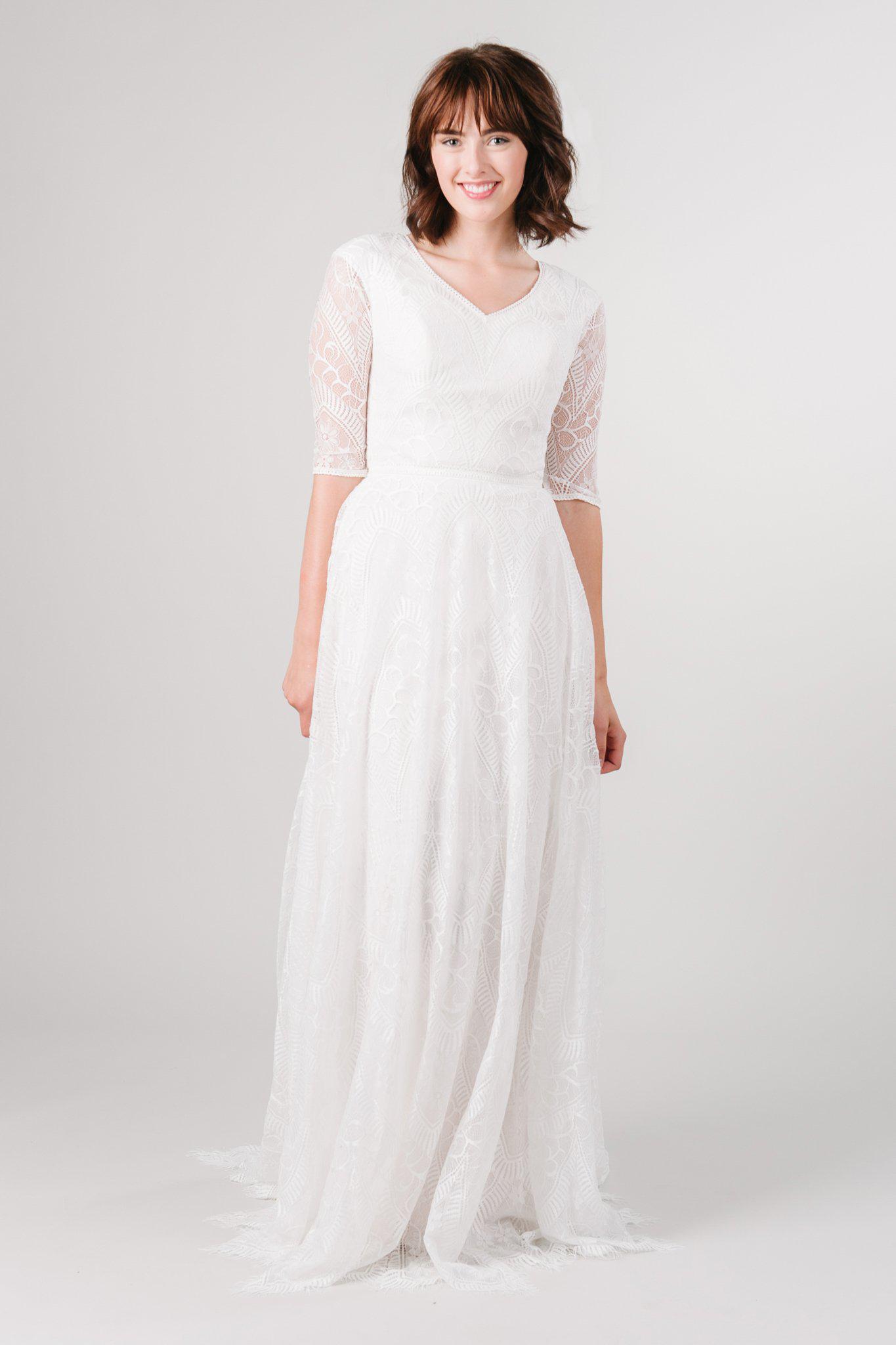 Front view of a modest wedding ballgown with lace details from LatterDayBride, a modest wedding dress shop in Salt Lake City, Utah
