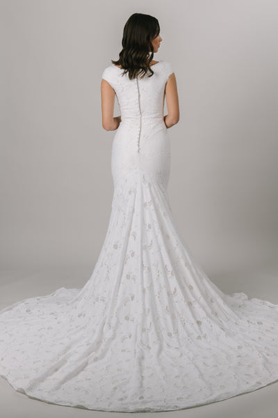 Fall in love with lace all over again! This stunning modest wedding dress features a sophisticated lace pattern, flattering fit-and-flare silhouette and an accentuated waistband that everyone loves!   Shown in Sand/Ivory. From a bridal shop called LatterDayBride in downtown Salt Lake City.