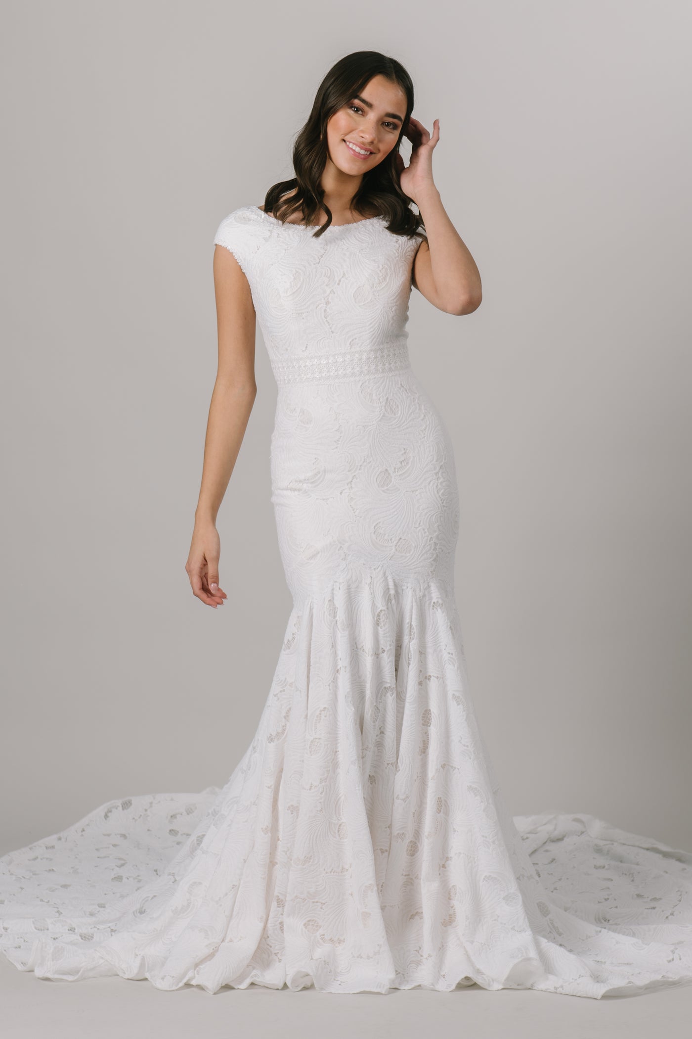 Fall in love with lace all over again! This stunning modest wedding dress features a sophisticated lace pattern, flattering fit-and-flare silhouette and an accentuated waistband that everyone loves!   Shown in Sand/Ivory.