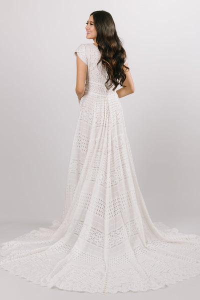 Modest all over lace wedding dress with a soft aline look and cap sleeves at bridal shop in salt lake city utah 