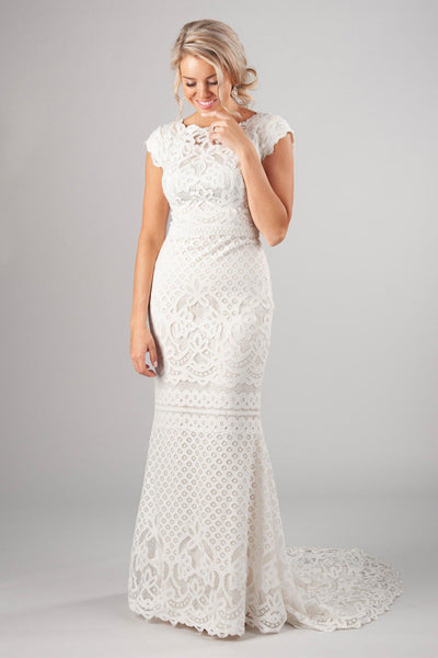 Boat neckline with delicate scalloped sleeves, style Luciana, is part of the Wedding Collection of LatterDayBride, a Salt Lake City bridal shop.