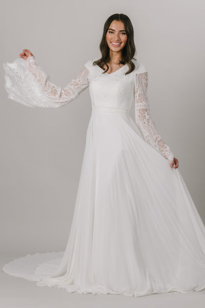 This modest wedding dress is perfect for our bohemian brides. The A-line silhouette makes it flattering on all figures. The unique lace on the bodice also makes for beautiful, flowy bell sleeves.