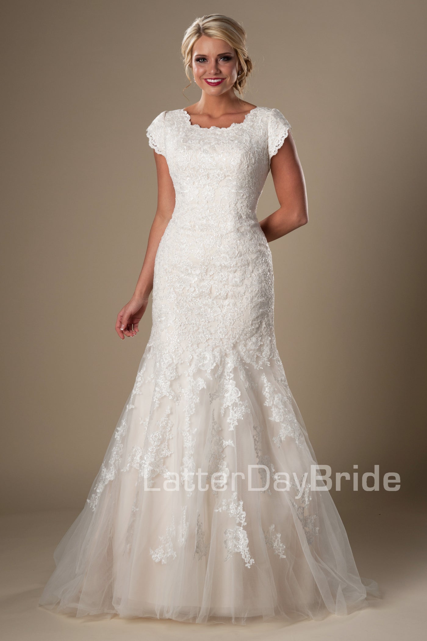 This darling modest bridal gown features a subtle splash of sequins decorating a soft lace and mermaid silhouette, modest wedding dresses, salt lake city, front view