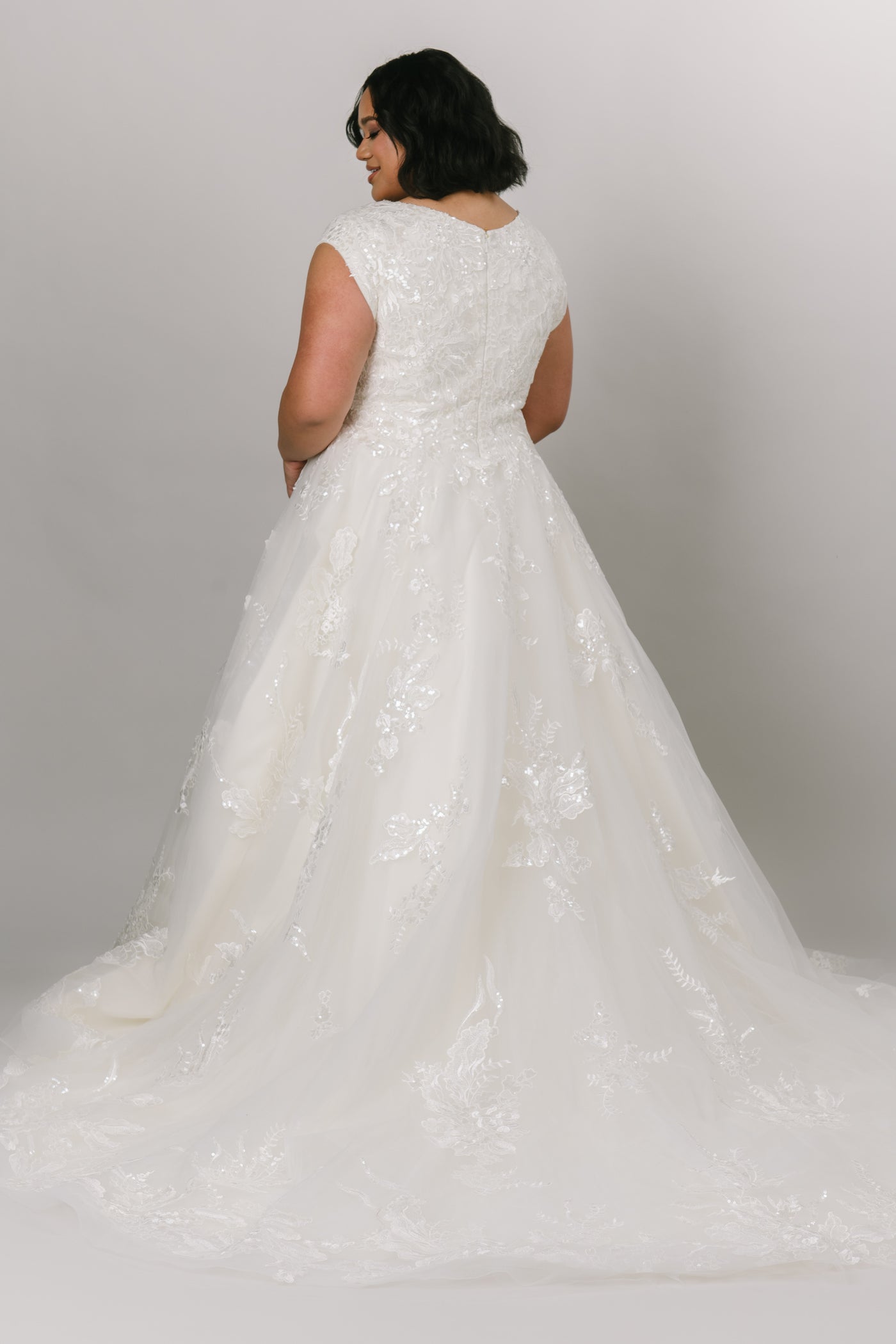 Plus size: Back view of modest wedding dress featuring a beautiful square neckline and ballgown silhouette.
