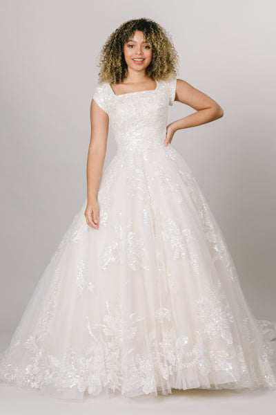 Front view of modest wedding dress featuring a beautiful square neckline and ballgown silhouette. 