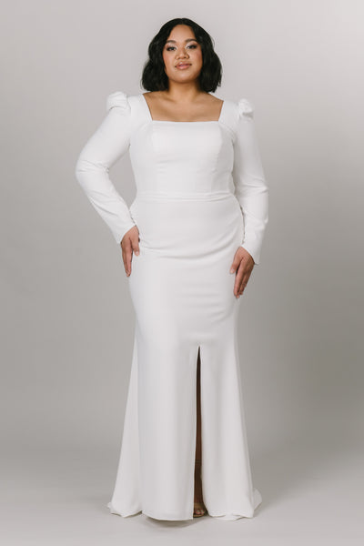 Plus size of modest wedding dress with long puffed sleeves. This dress is fitted with a knee high slit and a square neck line.