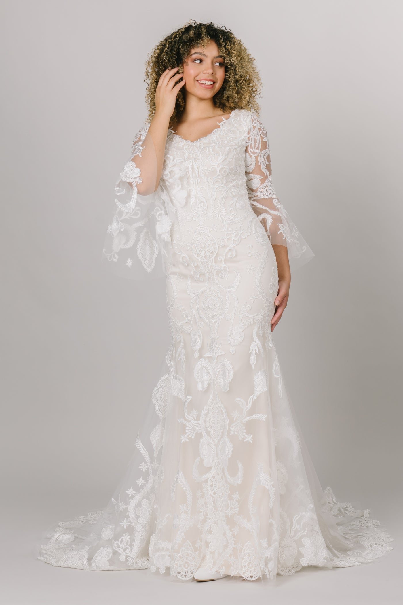 This modest wedding dress has a lace pattern and complemented with beautiful bell sleeves! 