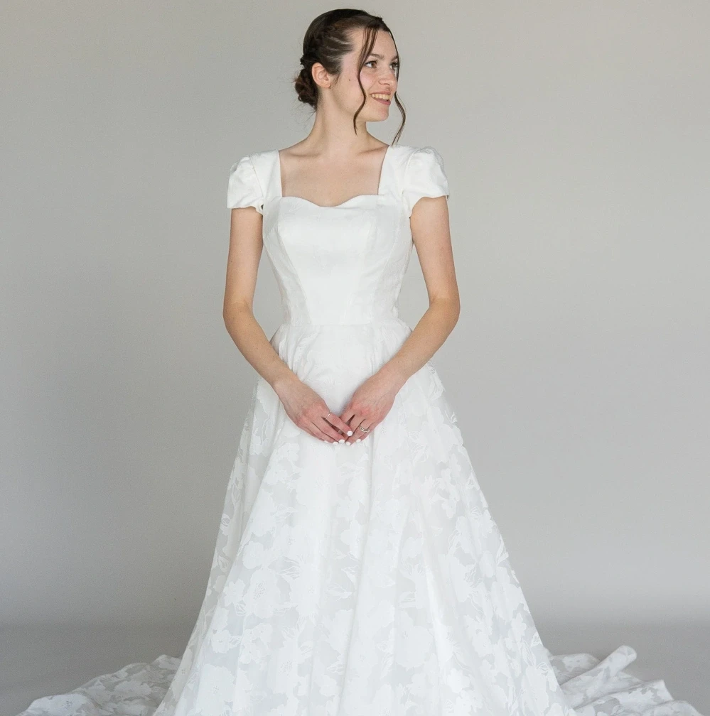 Model wearing an Modest Dresses $1500 - $1999 gown